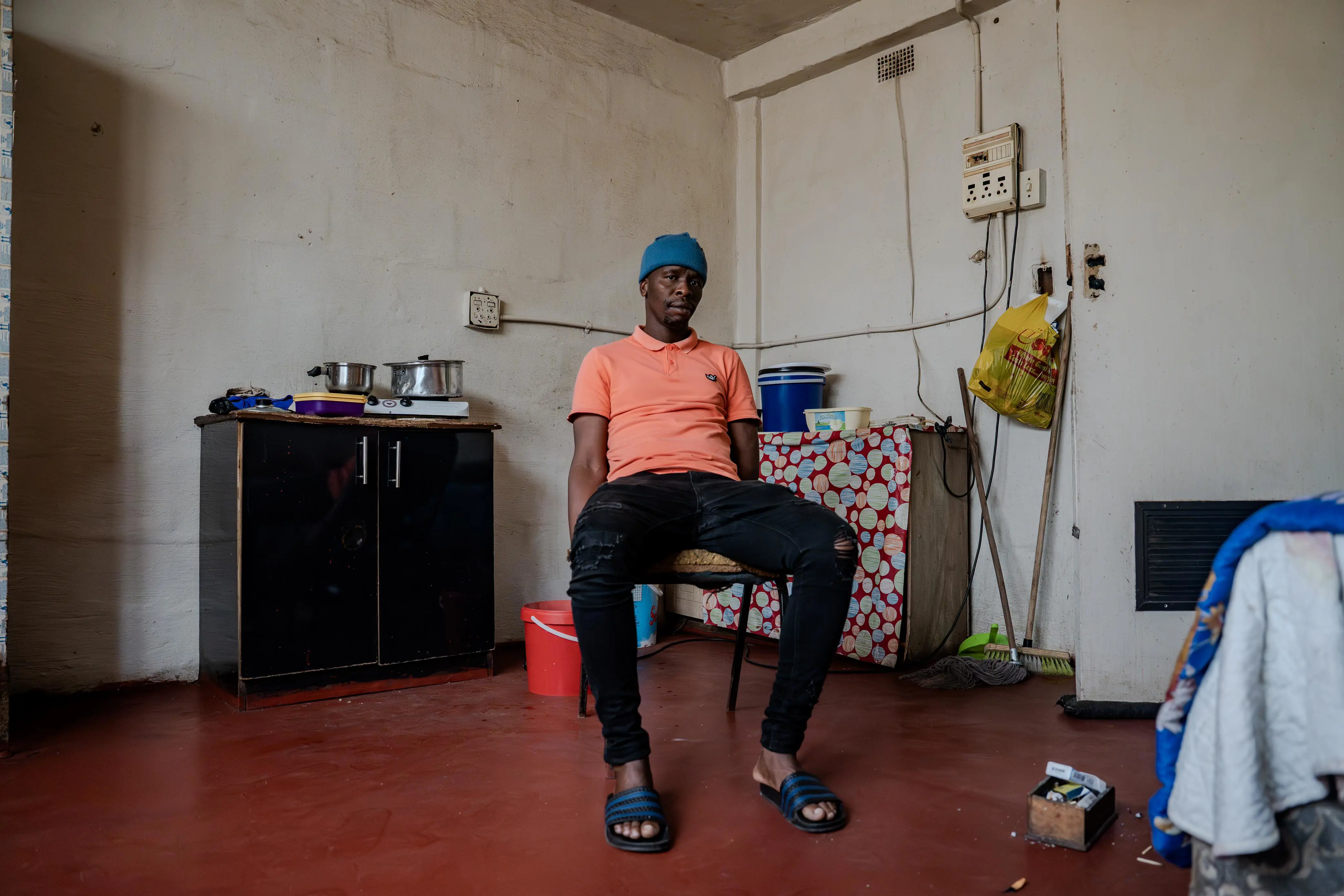 Inside his room, Nkululeko Mlangeni from KwaZulu-Natal offers a glimpse of life in the hostel. He came to Johannesburg chasing job opportunities, but now shares a space that reflects the tough realities many residents face. Photo: Sphamandla Dlamini/EWN Inside his room, Nkululeko Mlangeni from KwaZulu-Natal offers a glimpse of life in the hostel. He came to Johannesburg chasing job opportunities, but now shares a space that reflects the tough realities many residents face. Photo: Sphamandla Dlamini/EWN